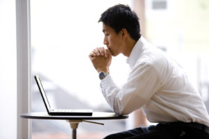 Man using laptop computer at internet cafe